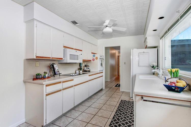There's a cooktop, wall oven, microwave, dishwasher, and side-by-side refrigerator.