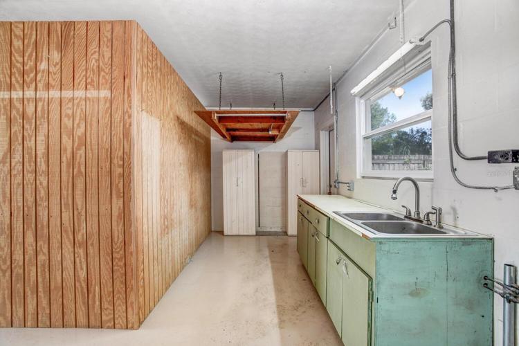 LOTS of storage space and a utility sink with a light over the window.