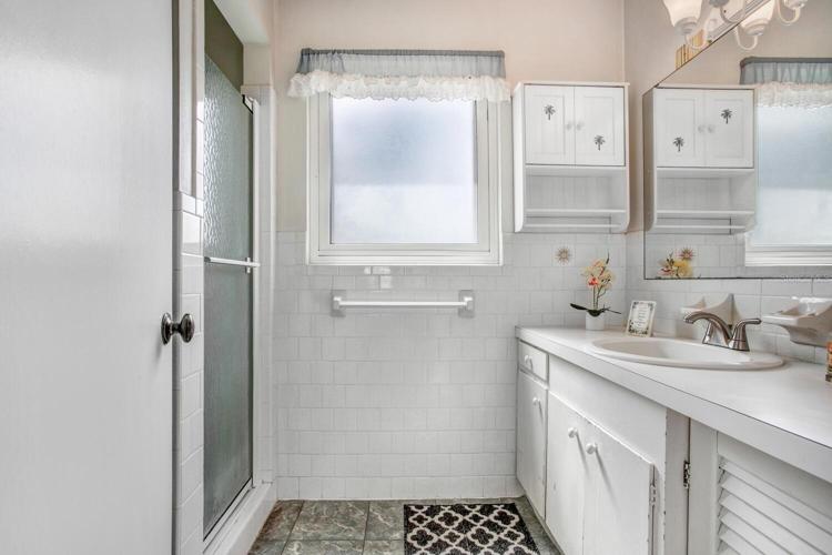 The master bathroom has a walk-in shower and a HEAT LAMP OVERHEAD!