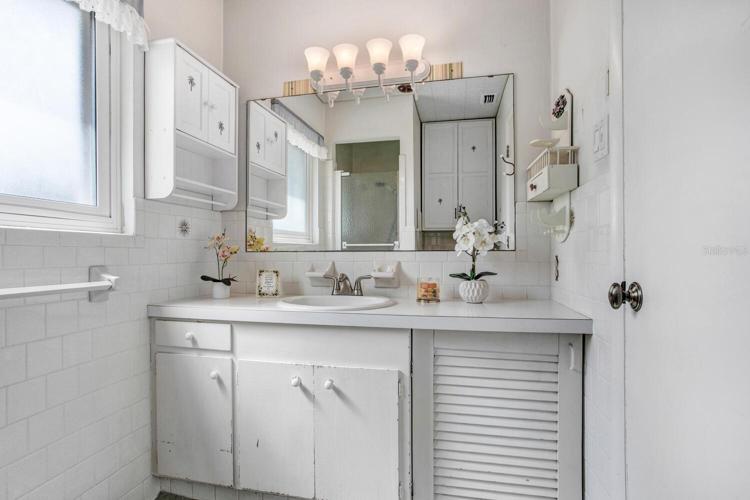 The master bathroom has a walk-in shower and a HEAT LAMP OVERHEAD!
