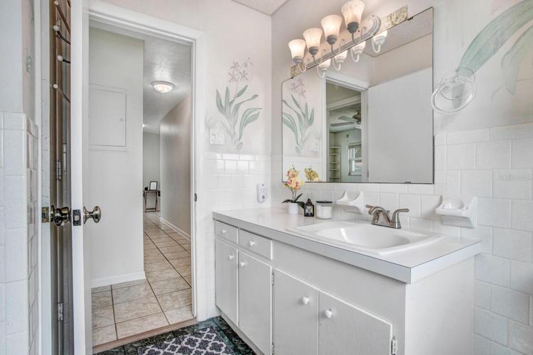 Hall bathroom w/ linen closet behind the door.