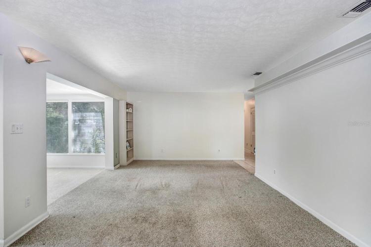 This is the family room!  The carpet is very easily replaceable, and the listing price reflects the flooring needing to be changed.
