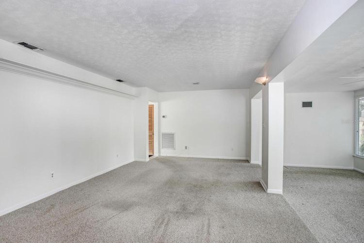 This is the oversized family room and Florida room!   The carpet is very easily replaceable, and the listing price reflects the flooring needing to be changed.