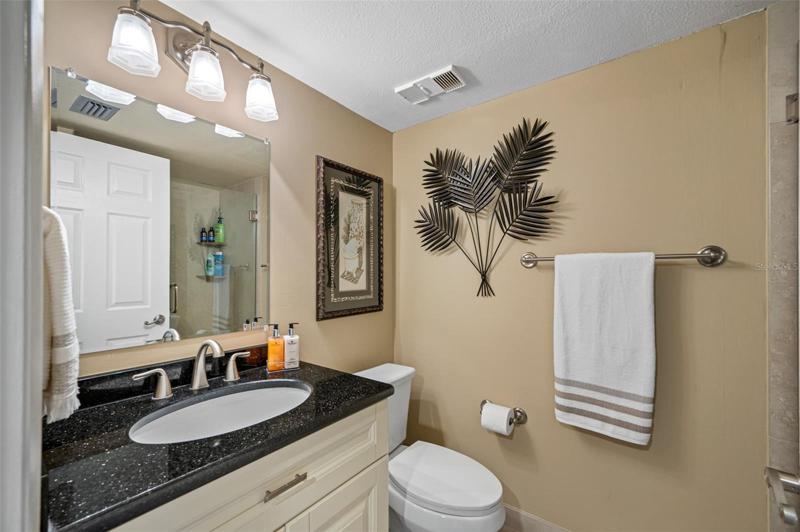 Bathroom has custom vanity with granite vanity top.