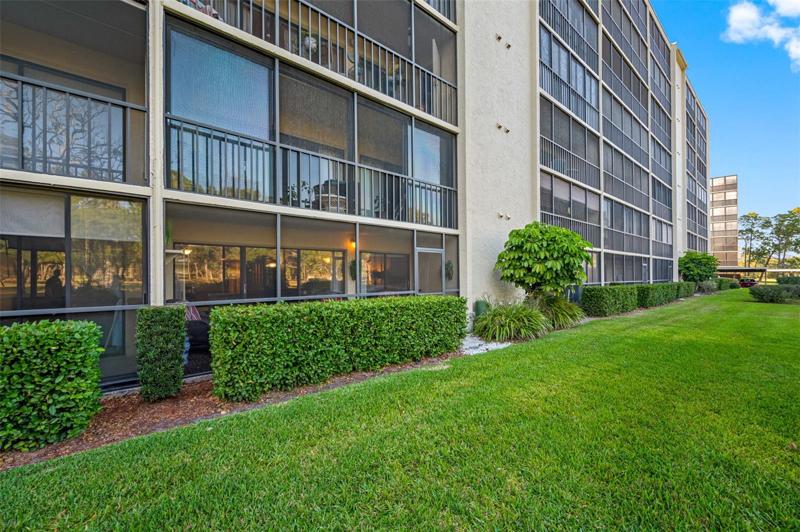Ground floor condo offers backyard view of lush green landscaping, a true Florida tropical setting.