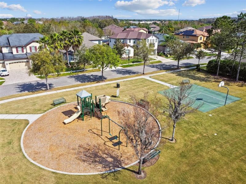 Community park within walking distance of the home.It has a playground and basketball courts. Plus open space to play games. Benches to relax too.