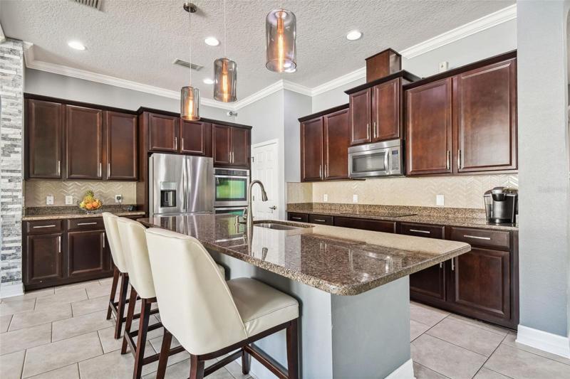 The kitchen has a gas cooktop and double wall ovens plus a built in microwave.