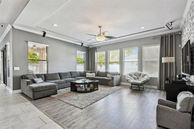 The family room is a great gathering space with room for your whole family. The decorative stone wall is a beautiful accent.