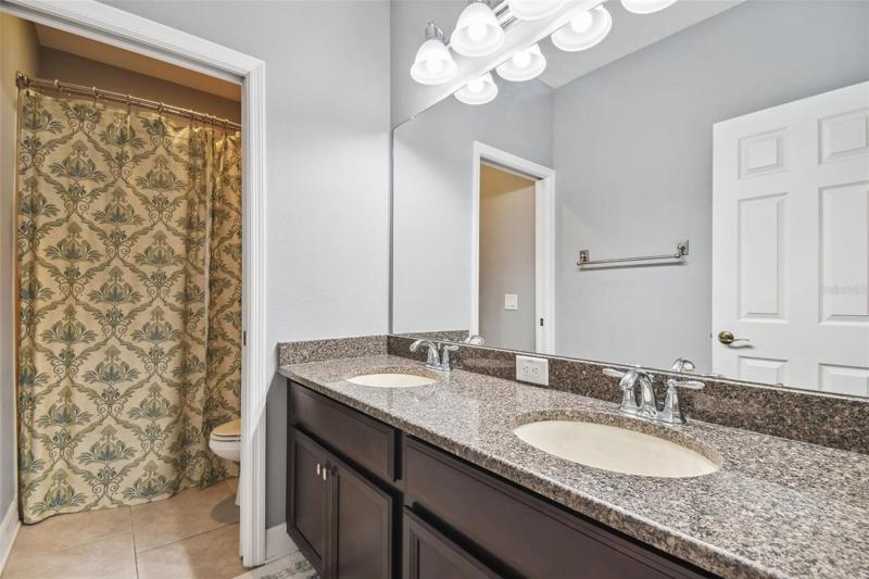 The hall bath on the second floor features a dual sink vanity and a tub/shower.