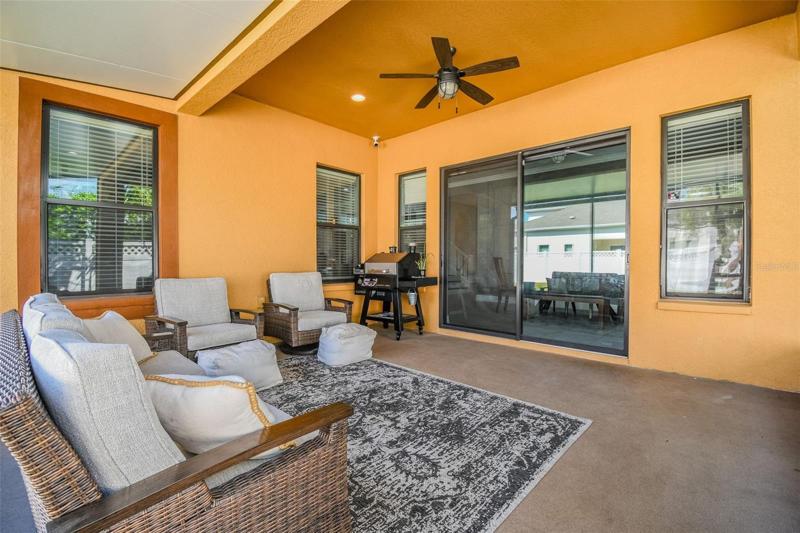 the covered and screened lanai has room for your outdoor sitting area, a grill and even a table. Room to hang a TV on the wall too!