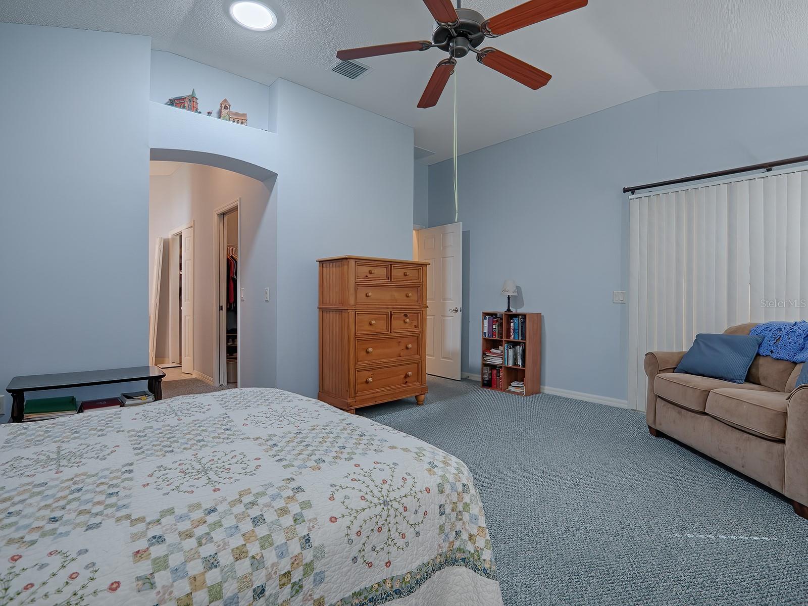 THIS VIEW SHOWS THE EN SUITE MASTER BATH ENTRANCE AND SLIDERS THAT LEAD TO THE LANAI