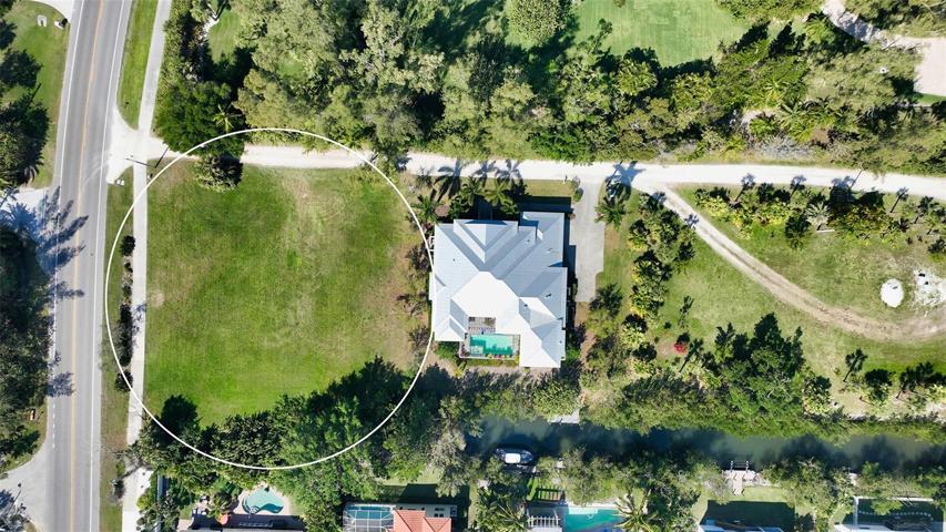 180ft of frontage on GOM Dr, 148ft deep on the North/Shinebone Alley side and 187ft deep on the South side of the lot