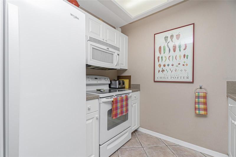 The kitchen appliances include a GE dishwasher, Whirlpool double door refrigerator, GE smooth top stove, and a Whirlpool microwave. 