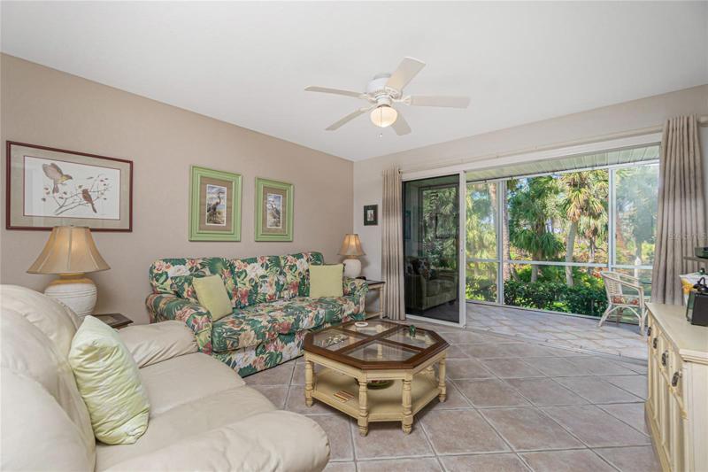 The living room has plenty of natural light from the Lanai ! When the sliding glass doors are open you can enjoy that indoor/outdoor living feel!