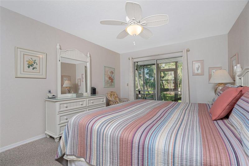 The master bedroom also features carpeted flooring and a ceiling fan.