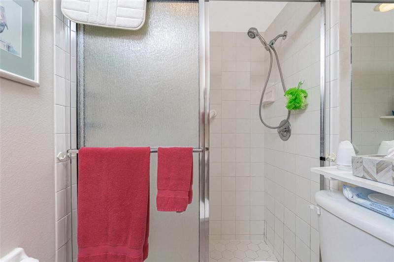The master bathroom features a walk in shower with glass door. 