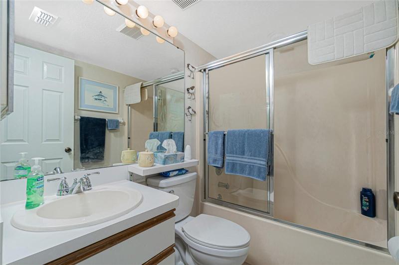 The guest bathroom features a tub/shower combo. 