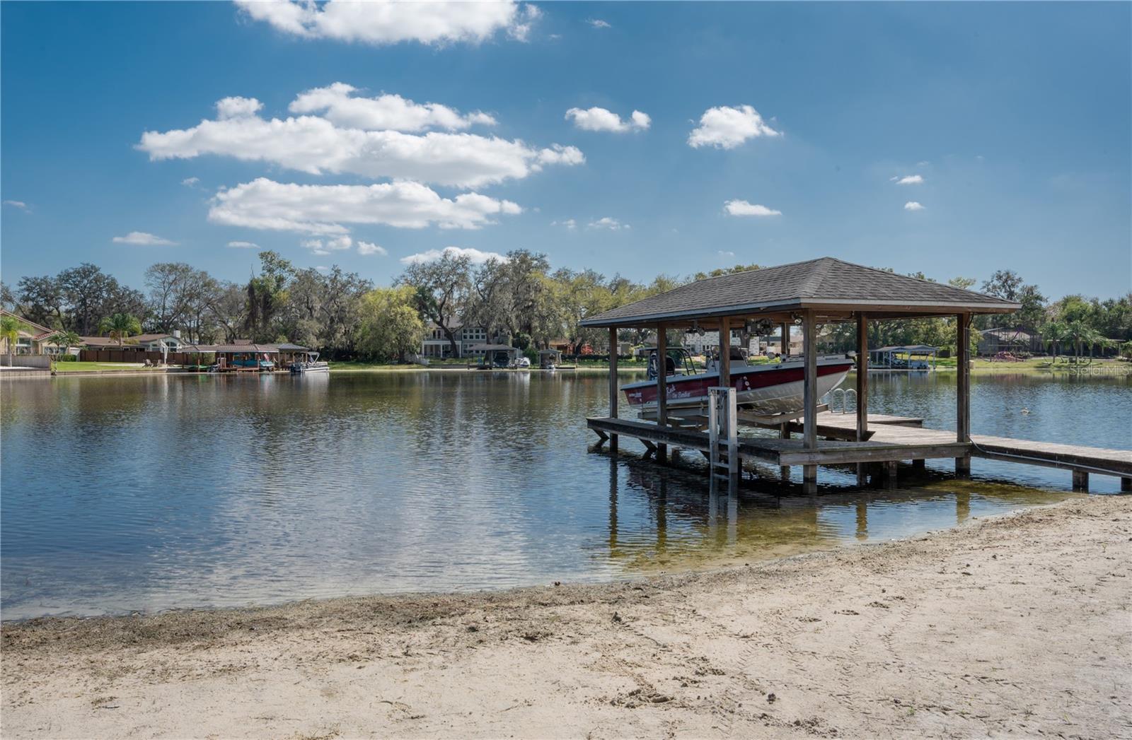 The covered boat dock has a boat lift.