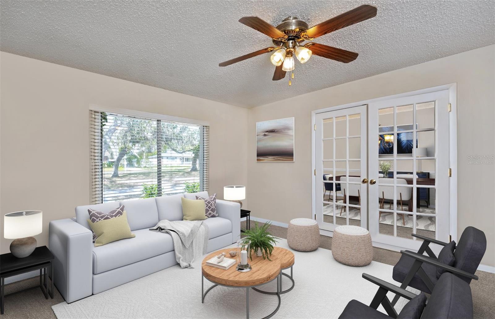 Virtually Staged- French doors are either side of this room that can be used as an office, den, or living room.