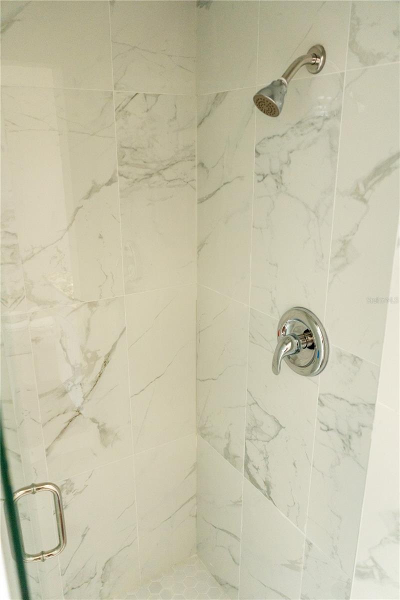 Stand in shower with glass enclosure in the master bath