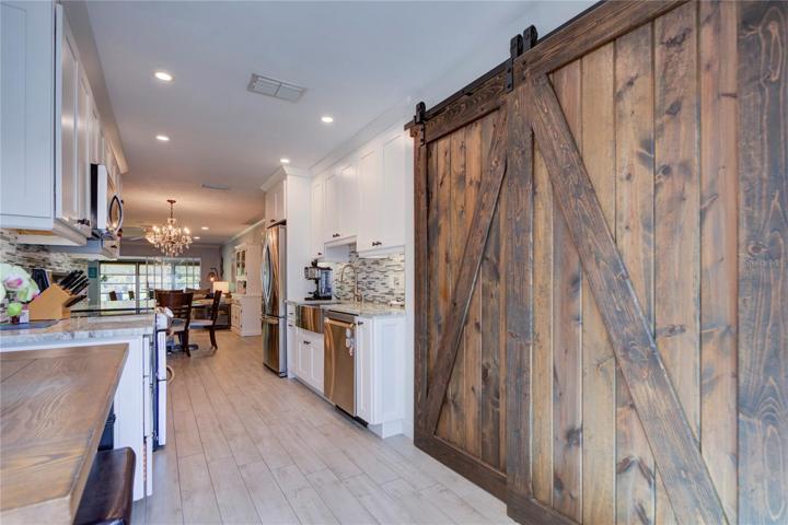 Kitchen pantry with beautiful wood barn doors