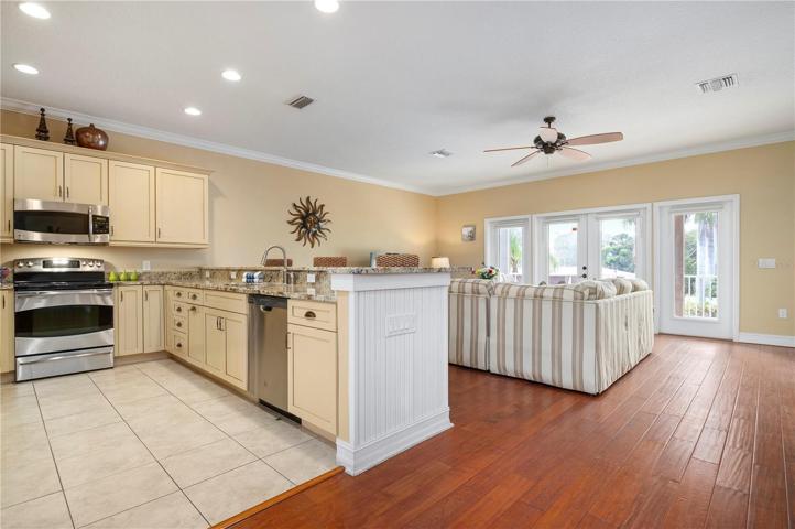 Open concept kitchen and living space with doors to the large covered patio