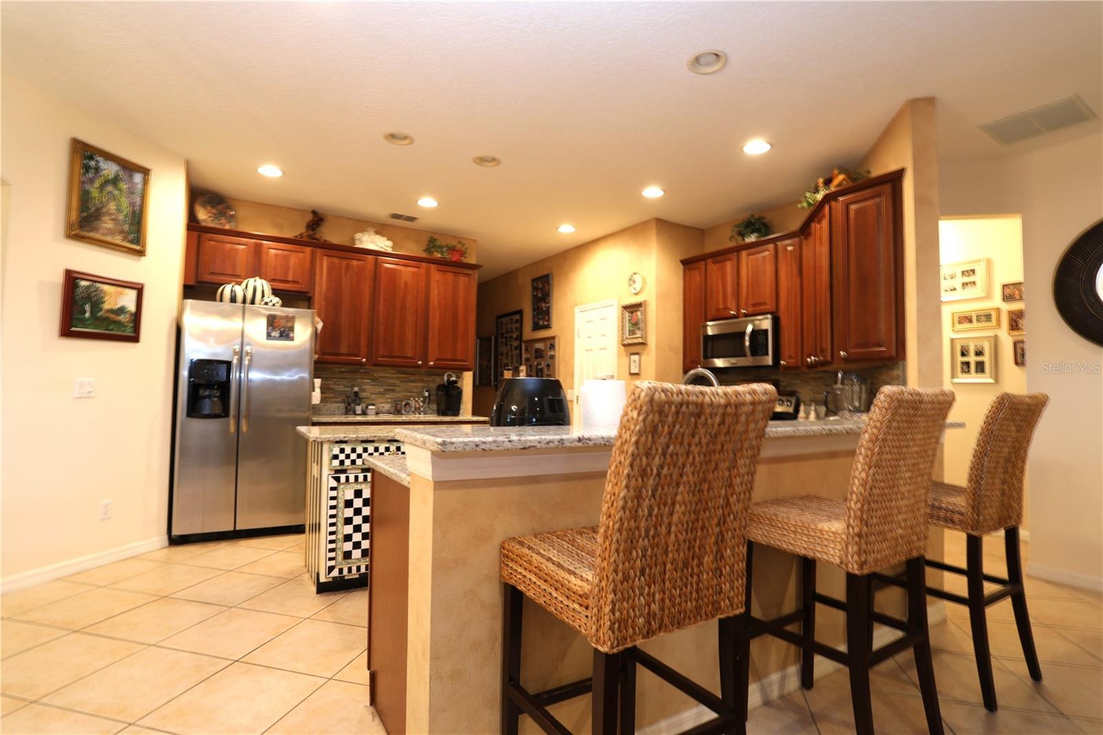 Kitchen with granite countertops, breakfast bar, 48-inch cabinetry and large island