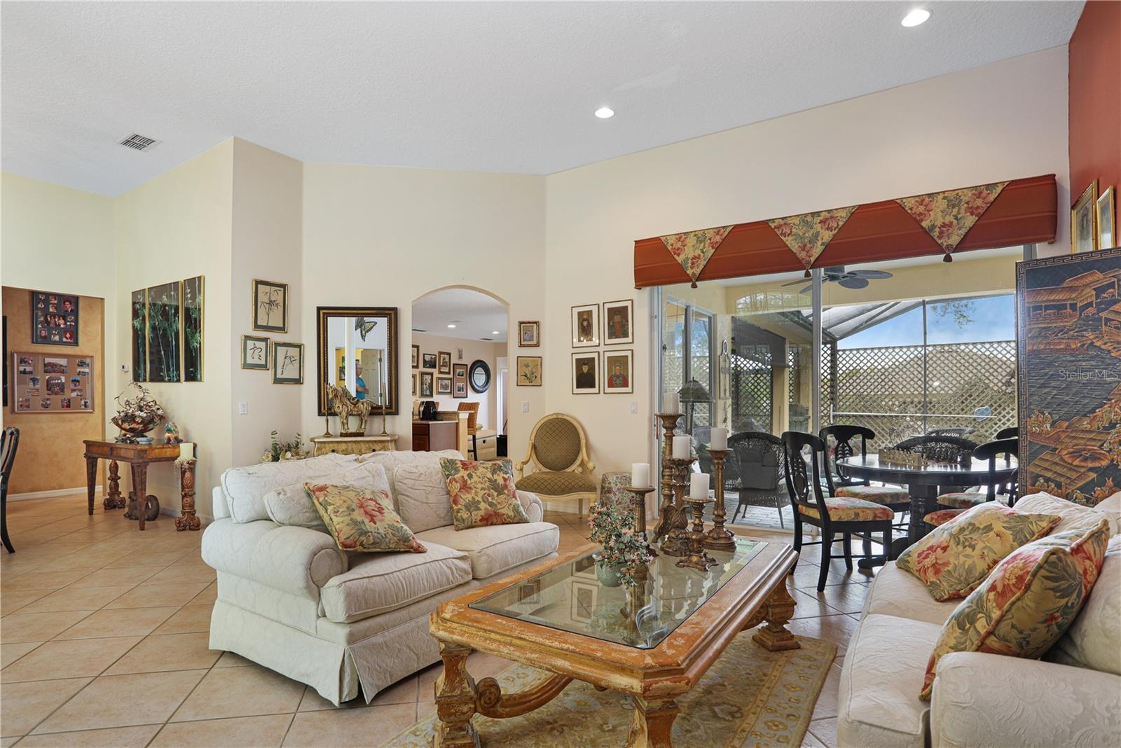 Living room looks out to the lanai and pool area.