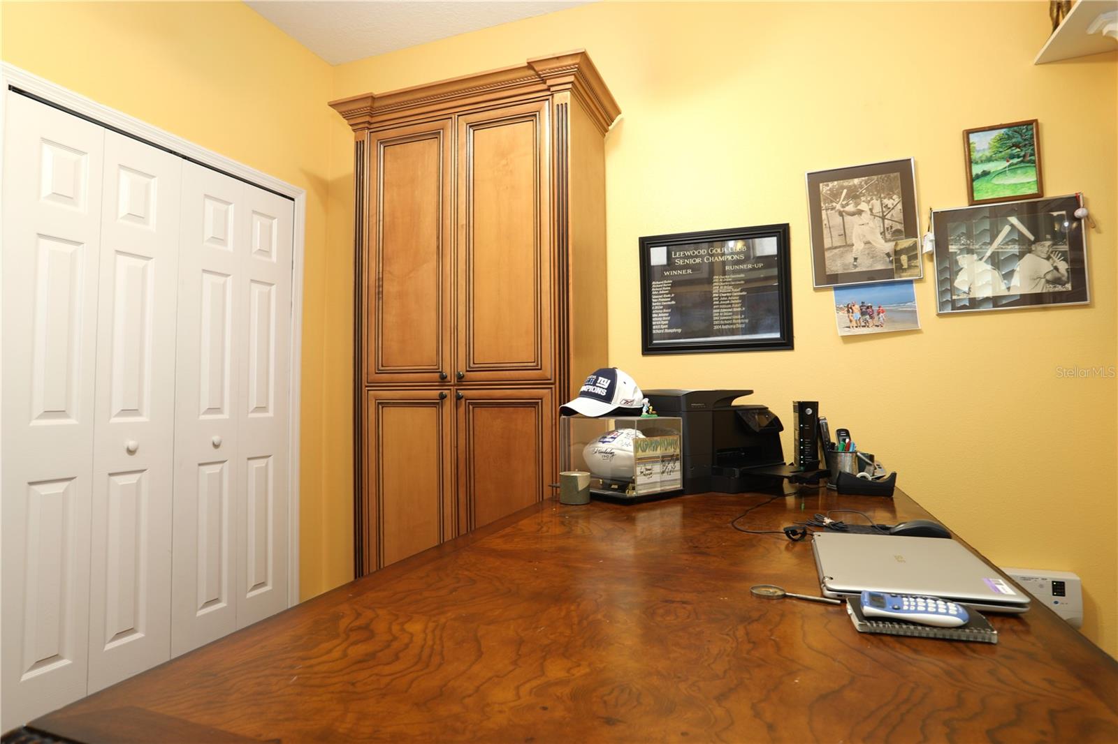 Bedroom 4, currently used as an office.   Has wood floors.