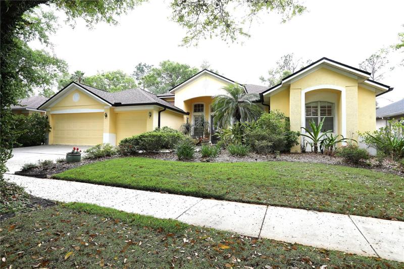 Exterior, lawn is zoysia grass and there are many different plants including gardenias, azaleas, ginger, lilies of the nile and roses.