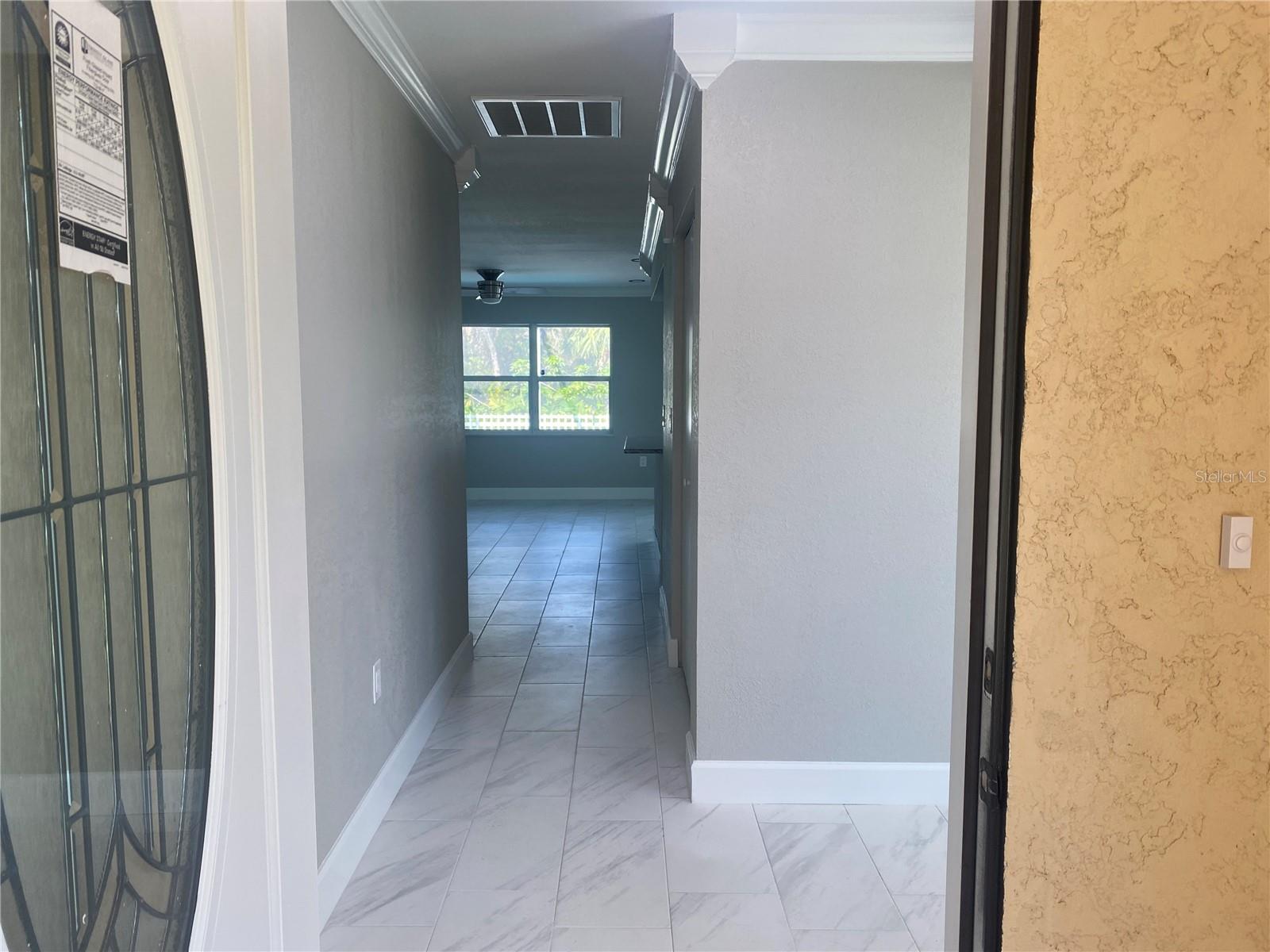 From the front door, looking into the foyer and down the hall to the family room.