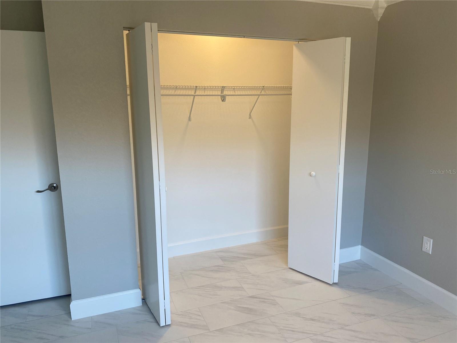 Bedroom #2's long closet (all the closets in this home are lighted except the linen).