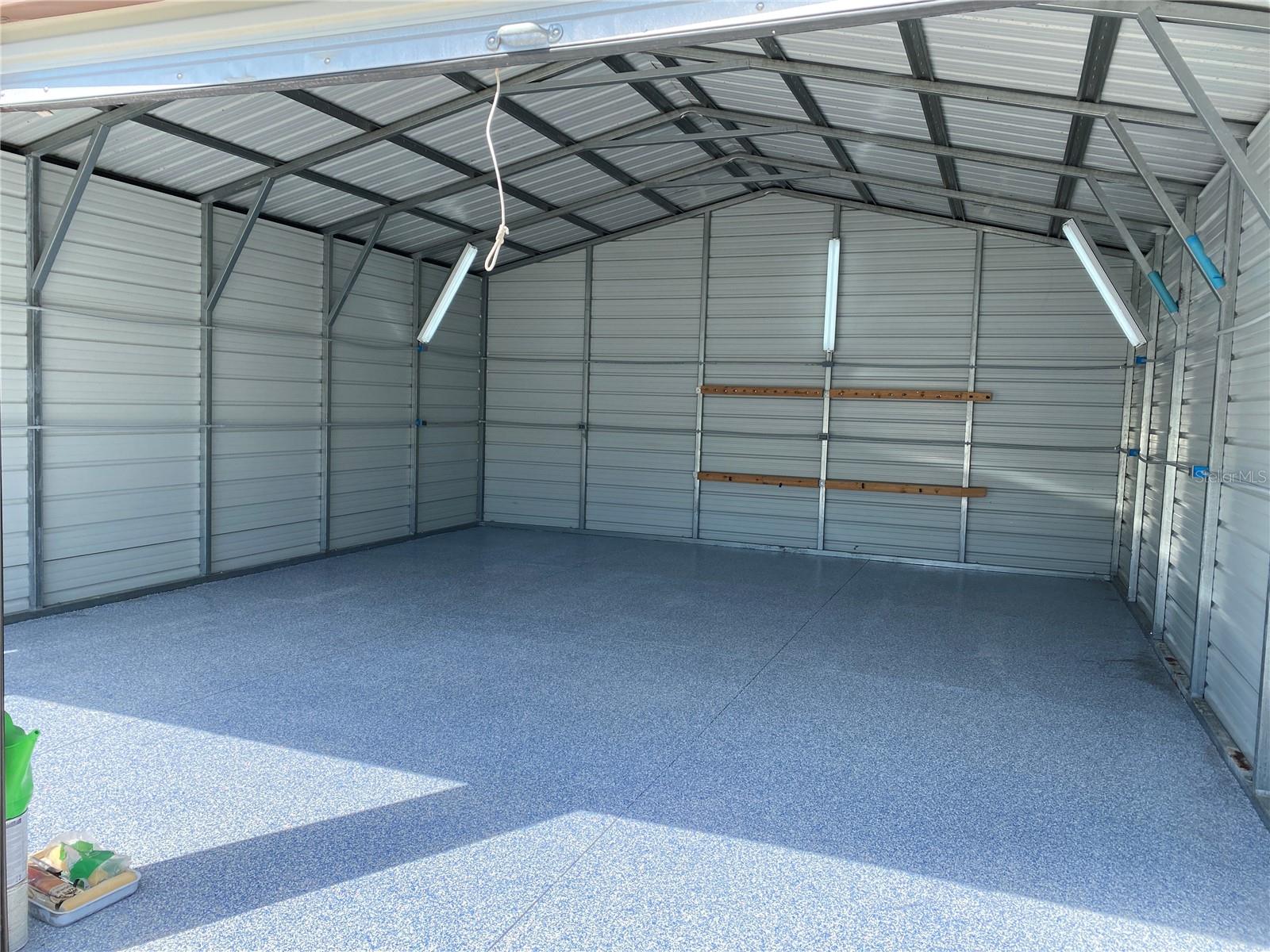 Huge parking or workshop space or both featuring a new epoxy floor coating, plenty of lighting, and 7 electric outlets.