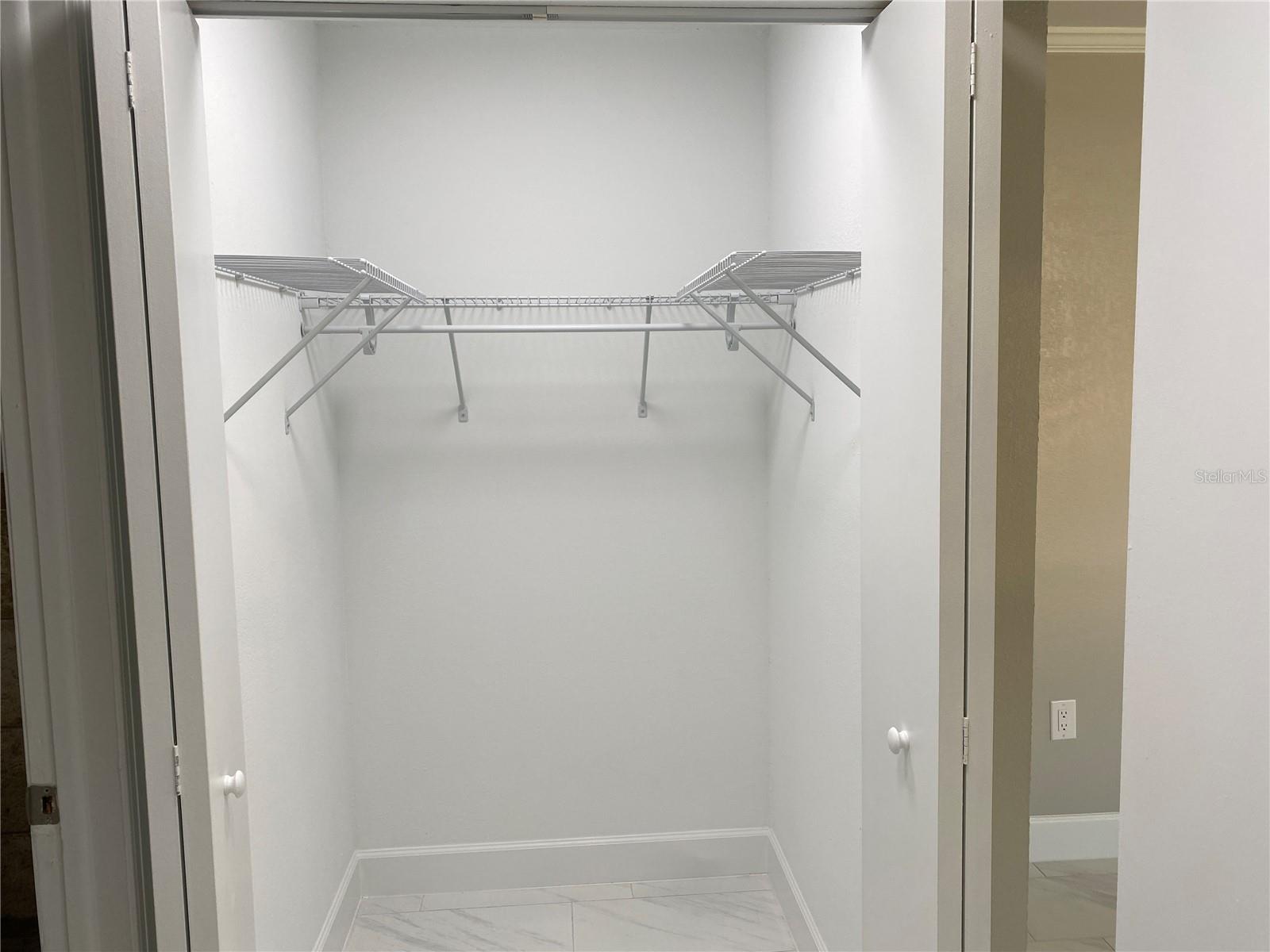 Master bedroom.  Hallway to closets and bathroom on the right.