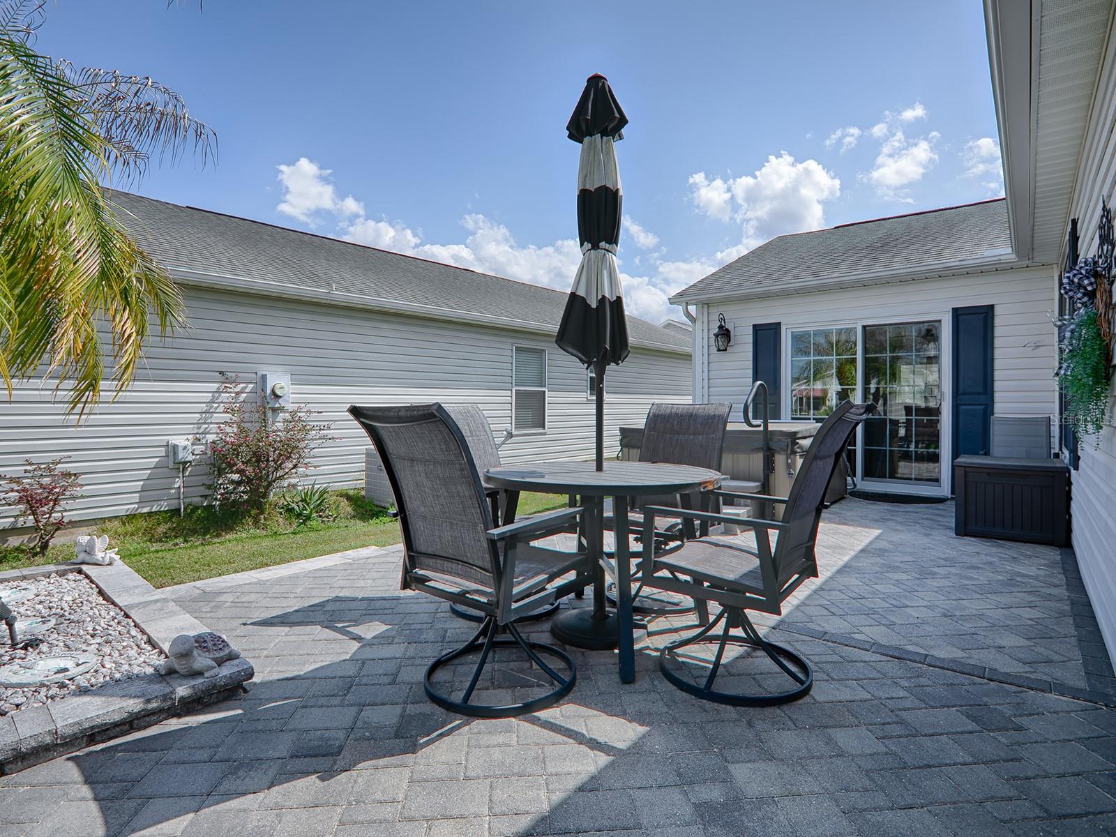 THE WRAP-AROUND SIDE PATIO HAS PLENTY OF SPACE FOR ENTERTAINING