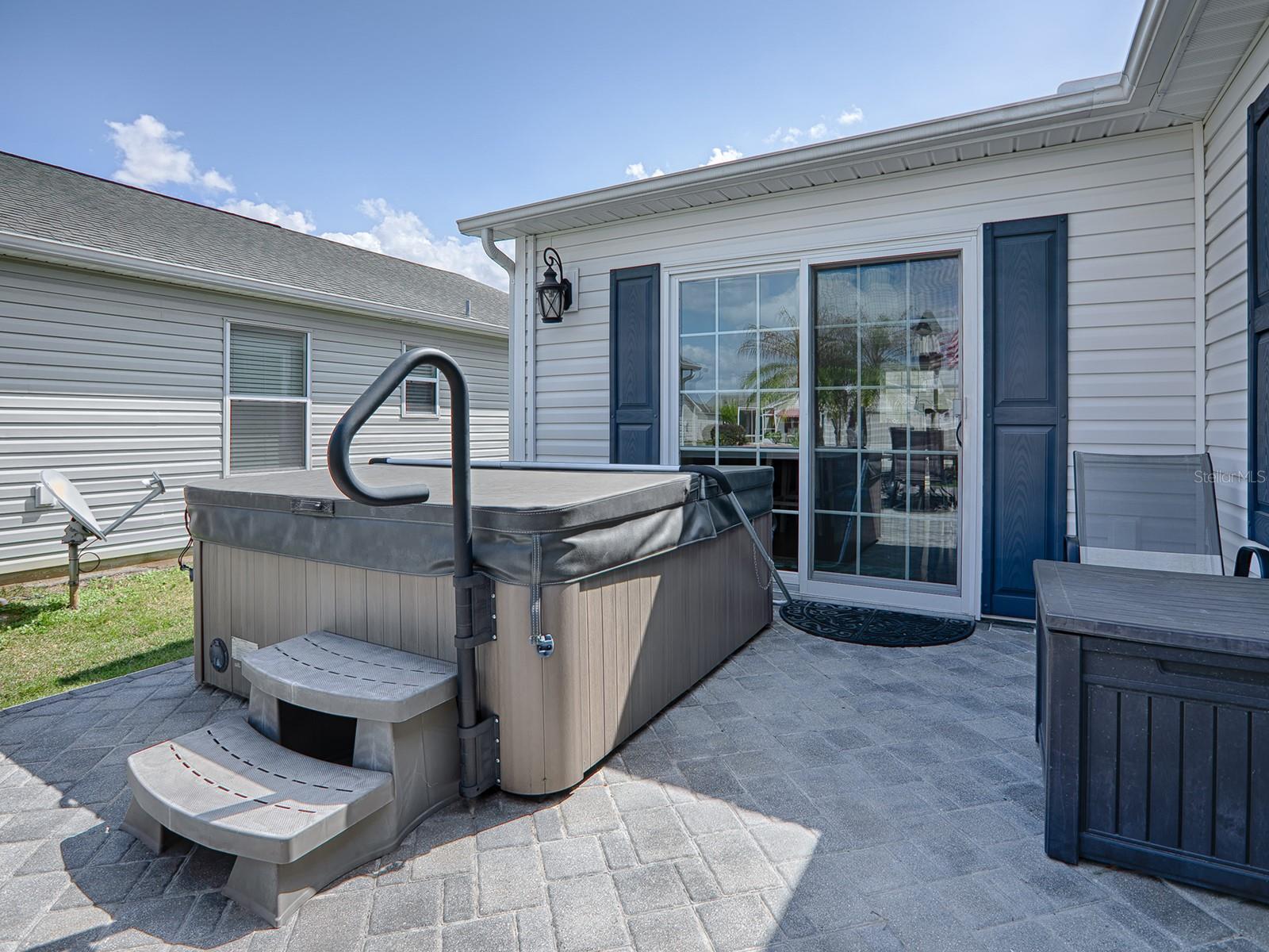 FANTASTIC HOT TUB!!! THE PANED-GLASS SLIDERS LEAD INTO A BEAUTIFUL 27 x 13 ADDITION.