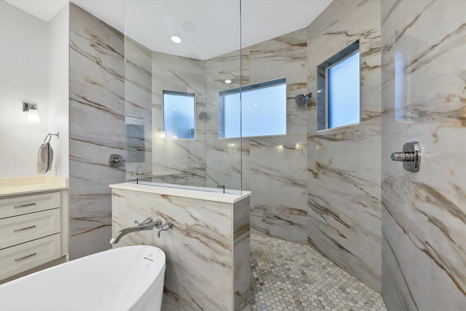Large shower area with trendy new fixtures.