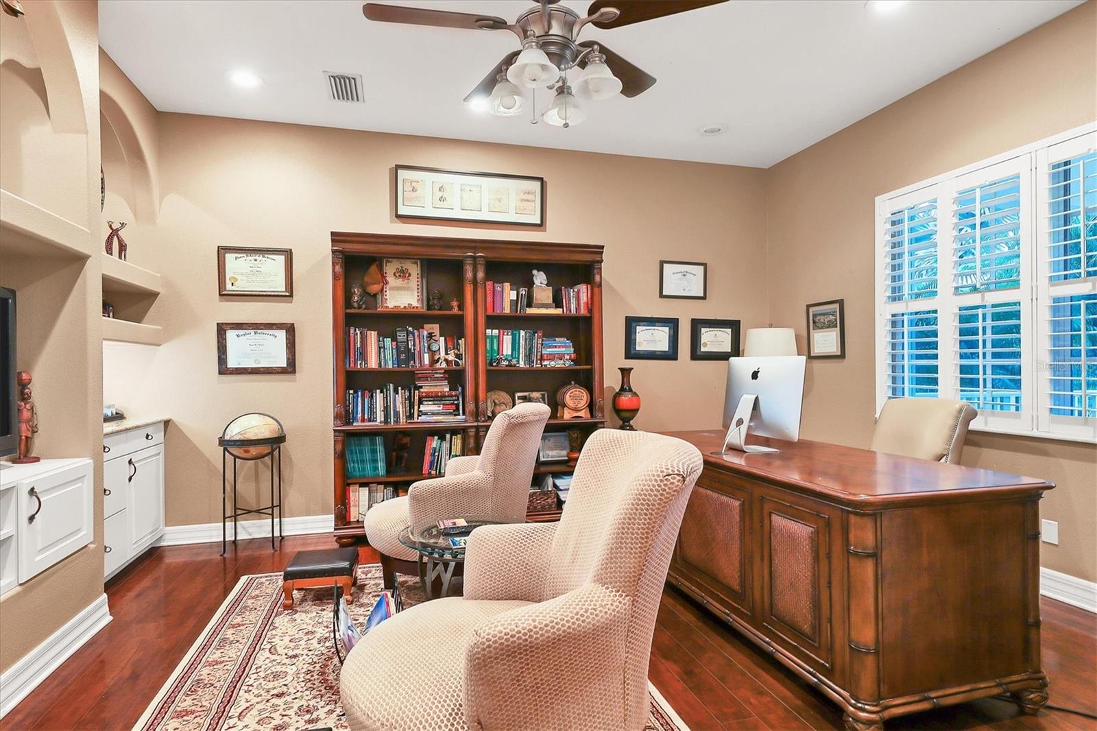 Stylish cabinetry and lighting in this office/den.