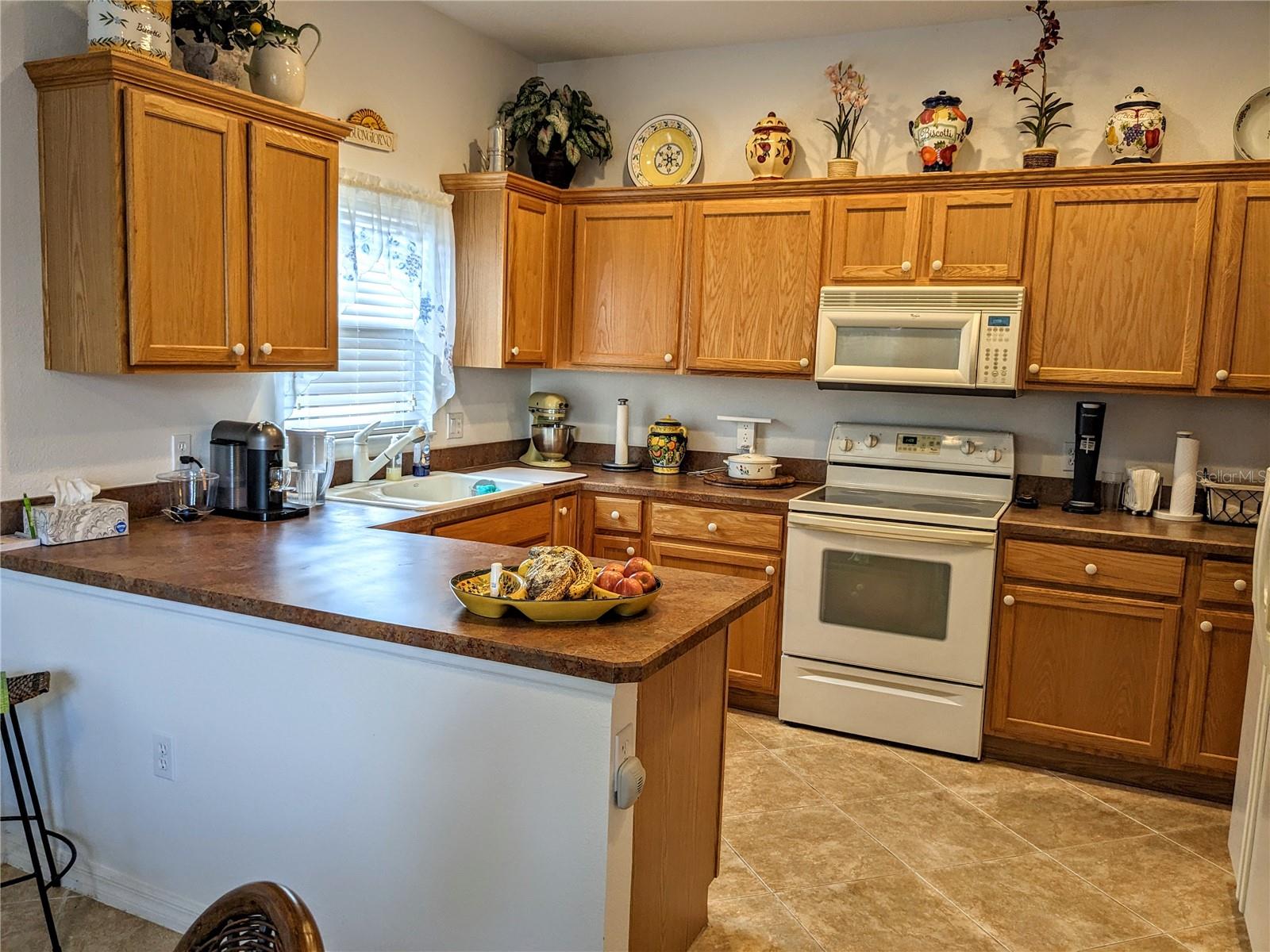 Bright airy kitchen with plenty of cabinet and counter space