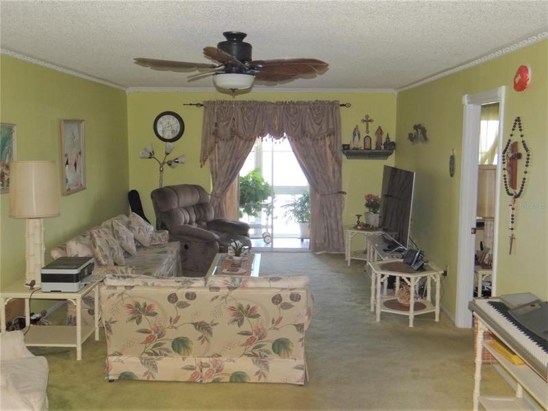 Living room with water views from private balcony