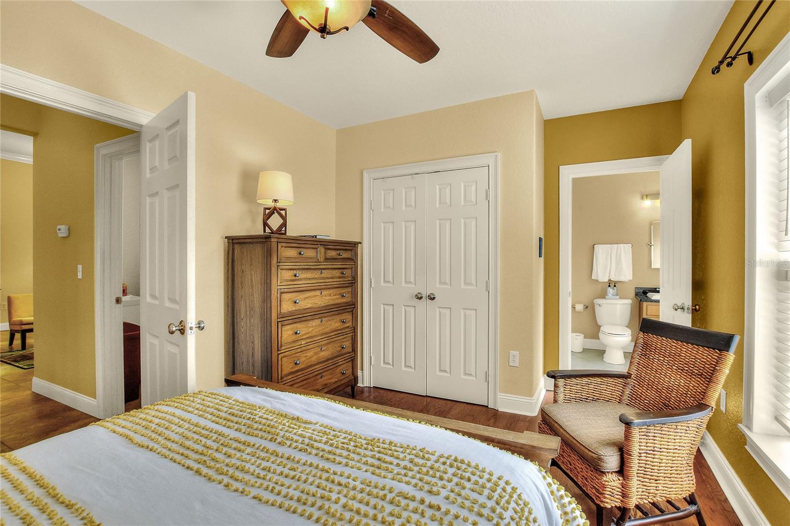 Bedroom 2 with real wood floors. Adjoining restroom.