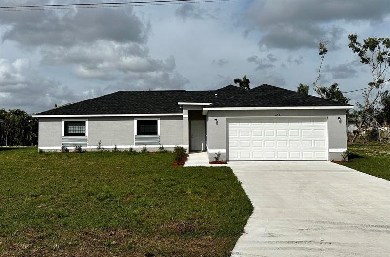 605 SE 2nd St, Cape Coral, FL 33990 -Front lawn and Garage