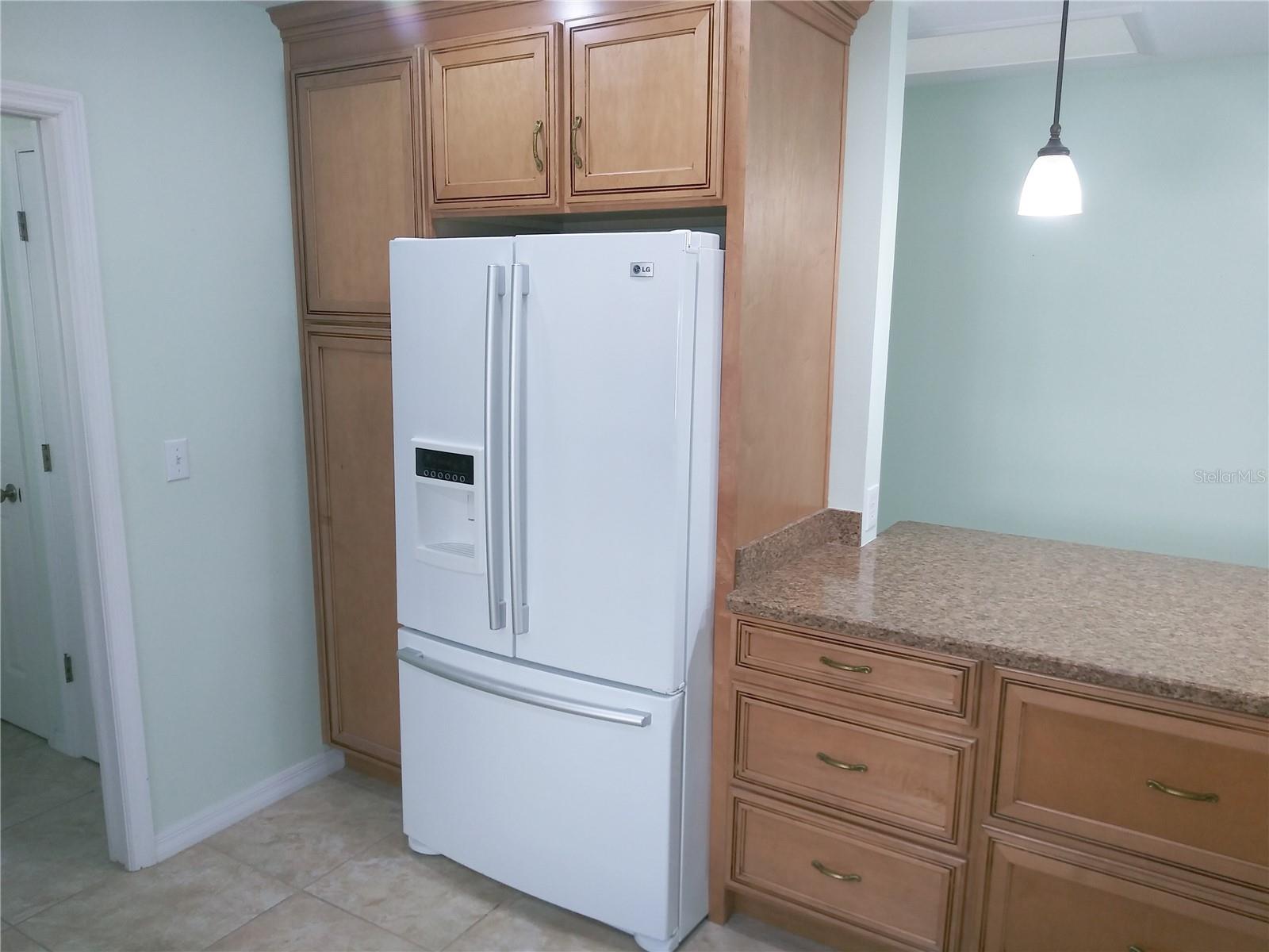 Kitchen. French door refrigerator, custom maple cabinets, granite look counter tops.