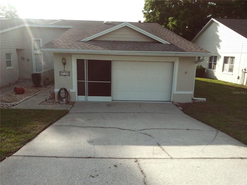 Front of the home. Sliding garage door screen.