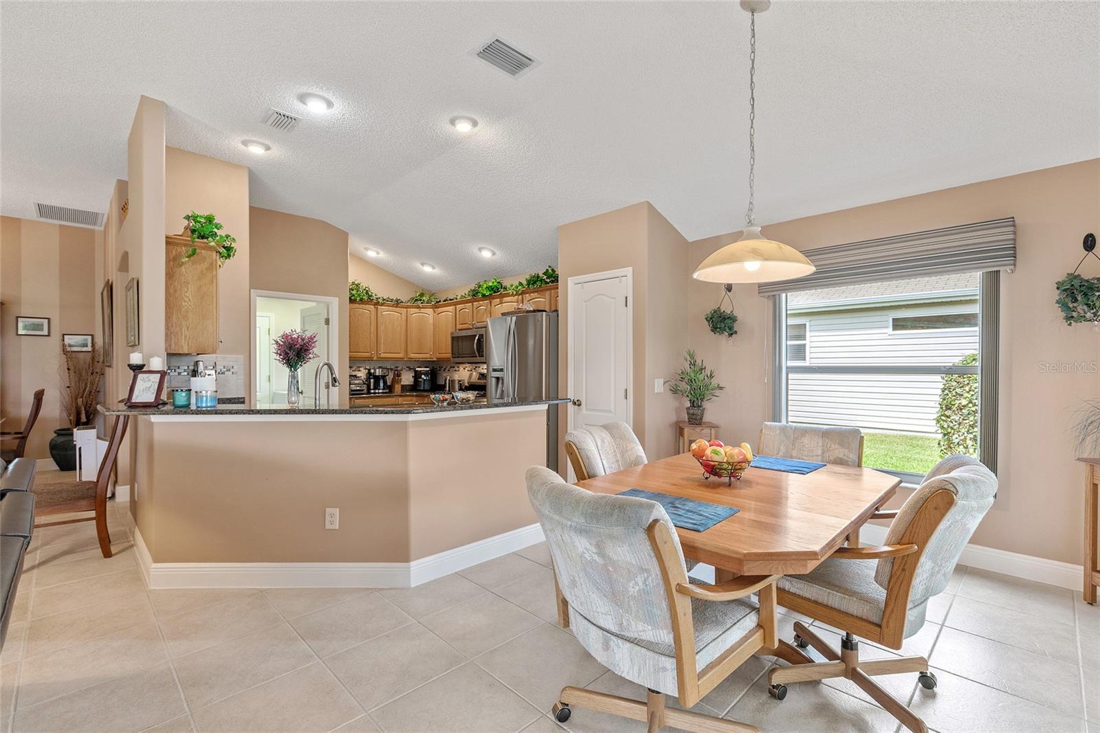 BREAKFAST BAR AND CASUAL DINING NOOK IN THE KITCHEN
