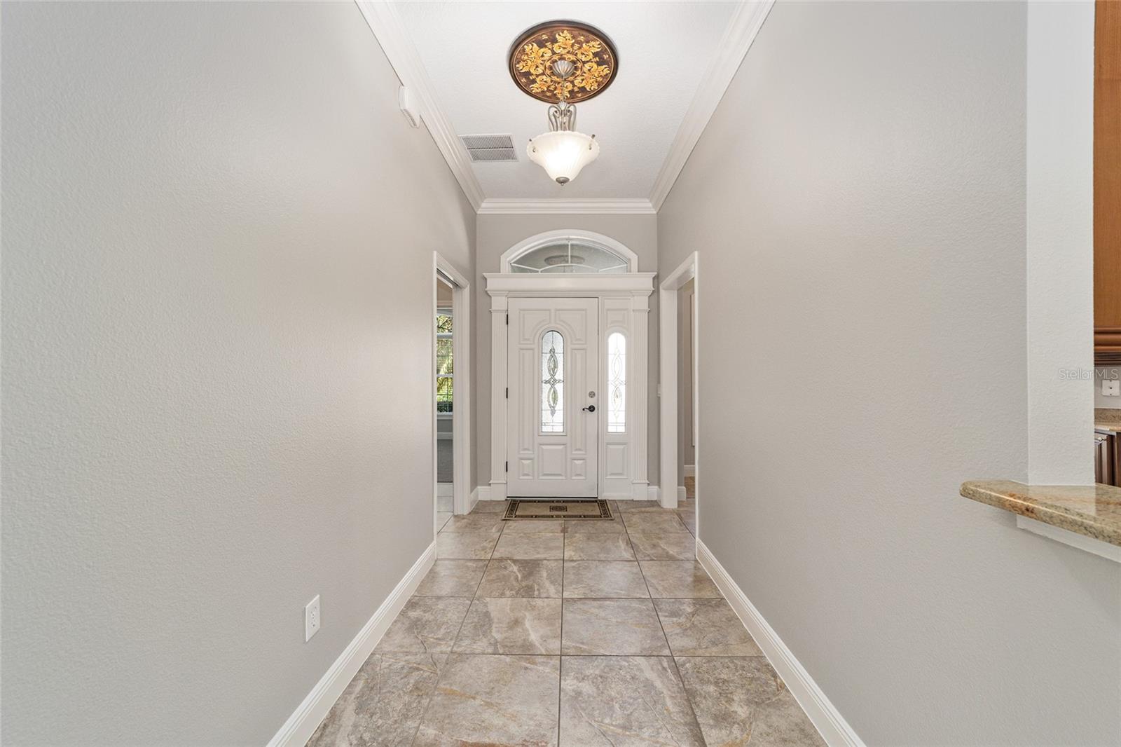 LOVELY LEADED FRONT DOOR WITH SIDELITE!  GUEST SUITE IS TO THE LEFT, KITCHEN IS TO THE RIGHT!