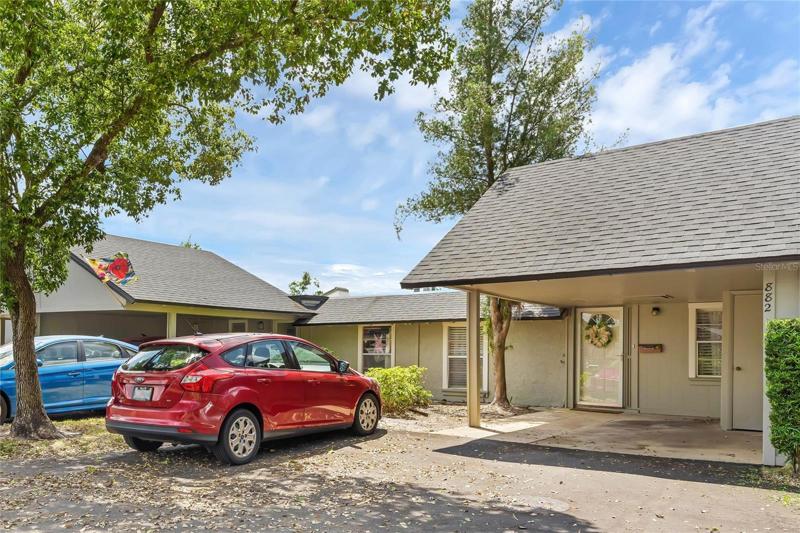 Front of home w/ private covered parking & ample guest parking.