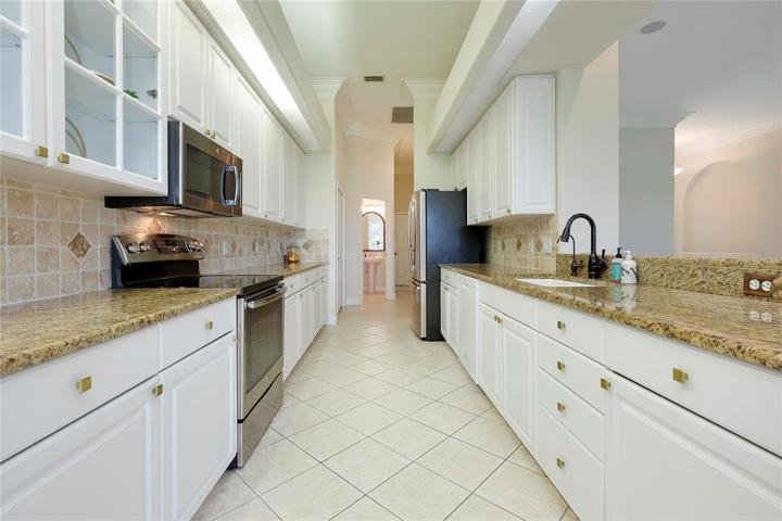 Galley Kitchen with great counter space and storage galore.