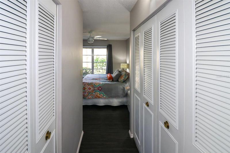 A hallway of closets separates the master bedroom from the master bathroom