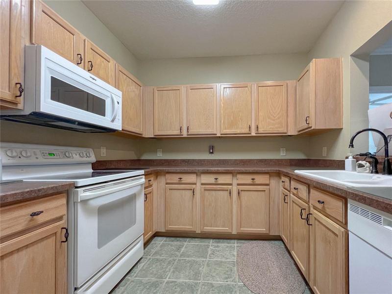 GORGEOUS KITCHEN HARD SURFACE COUNTERTOPS PLUS WOOD CABINETRY WITH CUSTOM-IRON PULL KNOBS... CERAMIC TILE FLOORING TOO! *ALL KITCHEN APPLIANCES STAY!
